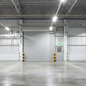 Roller shutter door and concrete floor inside factory building for industy background.